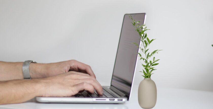 Human working on a Computer, creating Work Portfolio